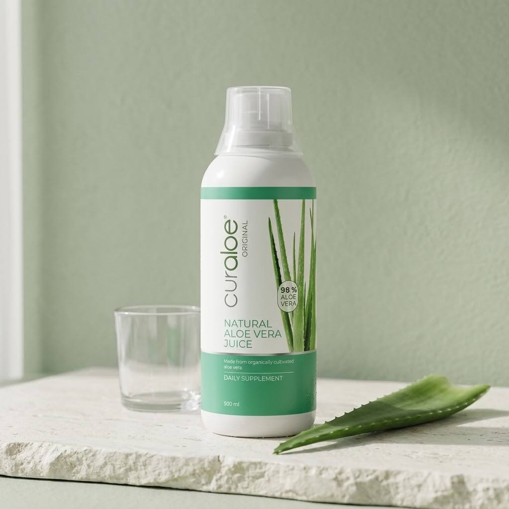 Curaloe natural Aloe vera juice 500ml bottle with an empty glass and a fresh aloe leaf